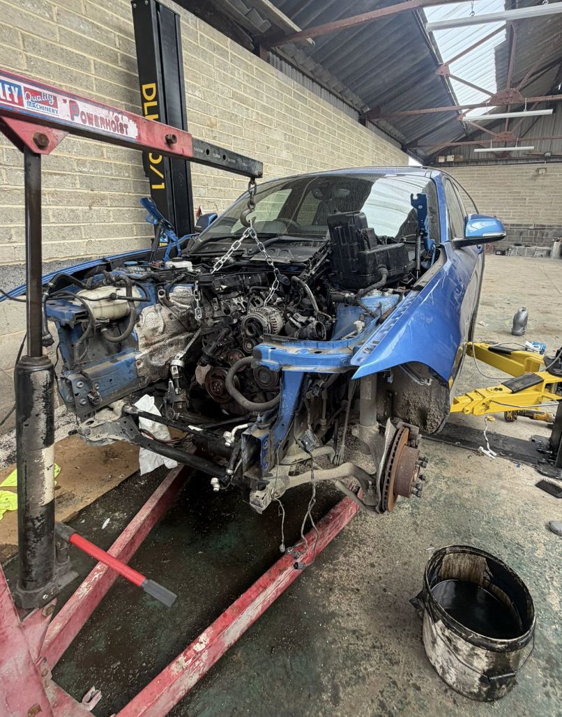 Engine being lifted out of a car during a repair at Elite Mechanics in Kent