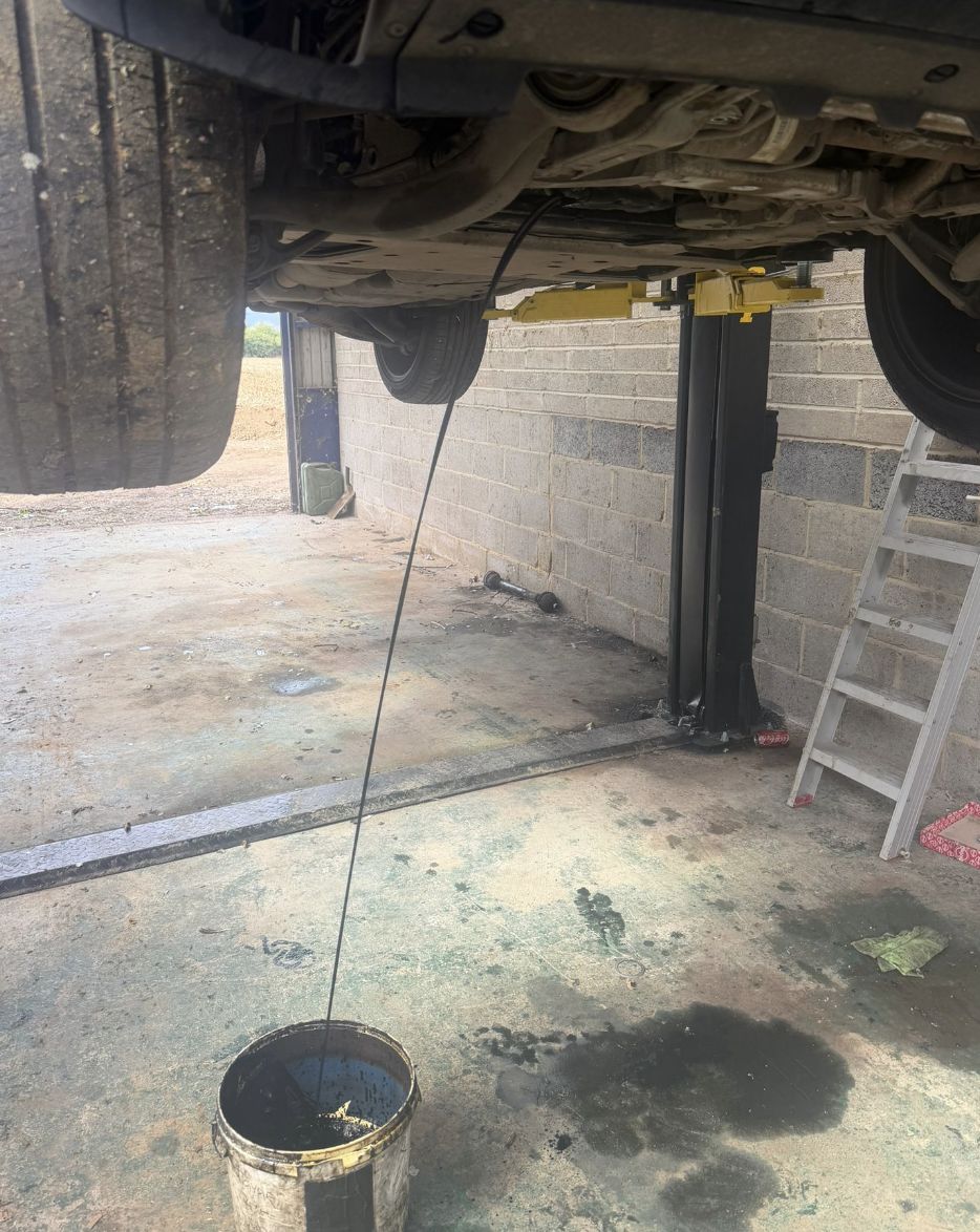 Engine oil being drained during a car service in Medway, Kent