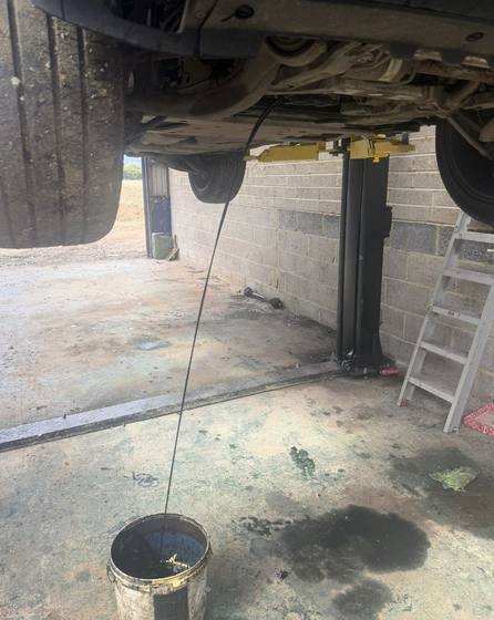 Oil being drained during a car service in Medway