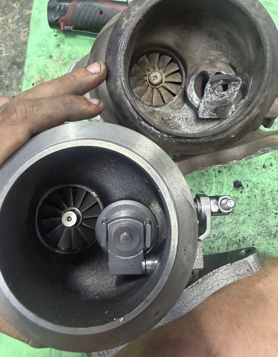 Failed turbocharger next to the replacement unit